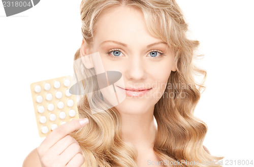 Image of young woman with pills