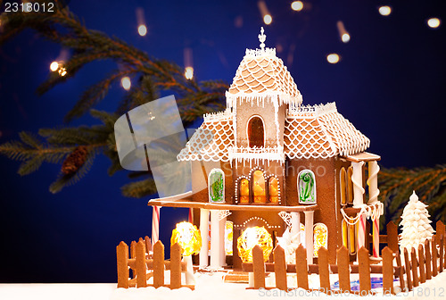 Image of gingerbread house over christmas background