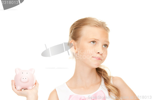 Image of lovely teenage girl with piggy bank