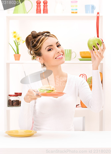 Image of woman with green apple and sandwich