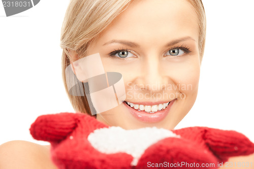 Image of beautiful woman in red mittens with snow