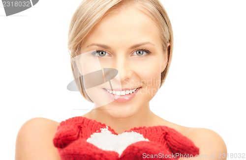 Image of beautiful woman in red mittens with snow