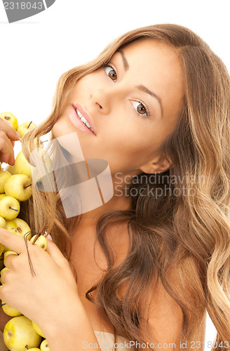 Image of lovely woman with green apples 