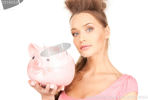 Image of lovely woman with piggy bank