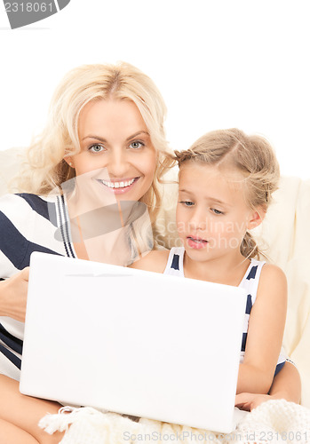 Image of happy mother and child with laptop computer