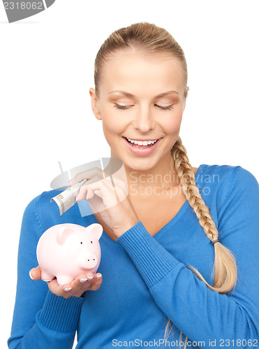 Image of lovely woman with piggy bank and money