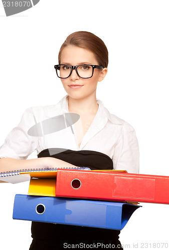 Image of young attractive businesswoman with folders 