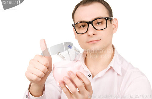 Image of businessman with piggy bank and money