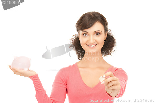 Image of lovely woman with piggy bank and money