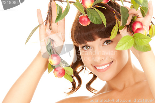 Image of happy woman with apple twig