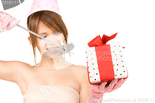 Image of teenage party girl with magic wand and gift box