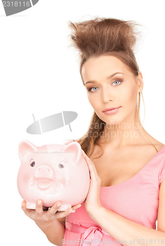 Image of lovely woman with piggy bank