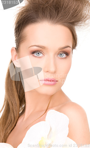 Image of beautiful woman with white flower