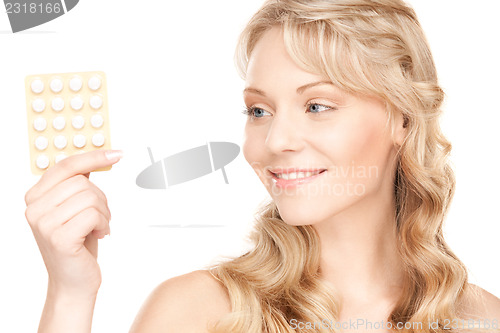 Image of young woman with pills