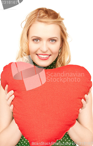 Image of woman with red heart-shaped pillow