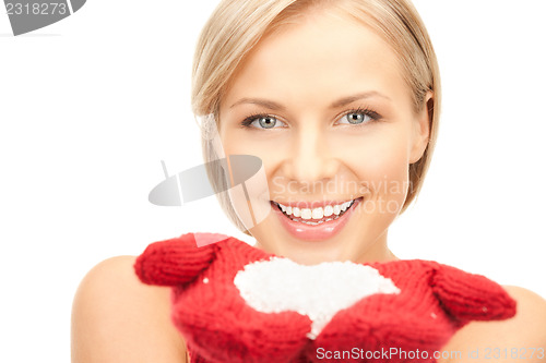 Image of beautiful woman in red mittens with snow