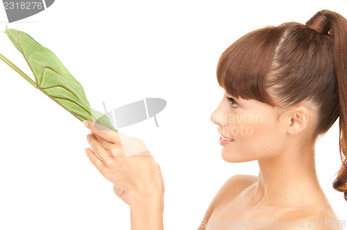Image of woman with green leaf