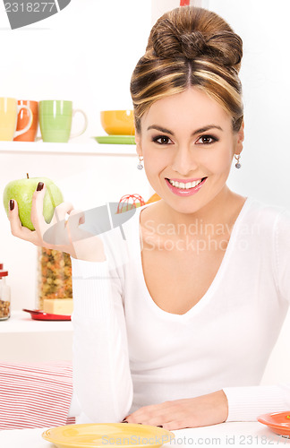 Image of young beautiful woman with green apple
