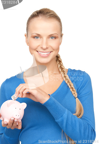 Image of lovely woman with piggy bank and money