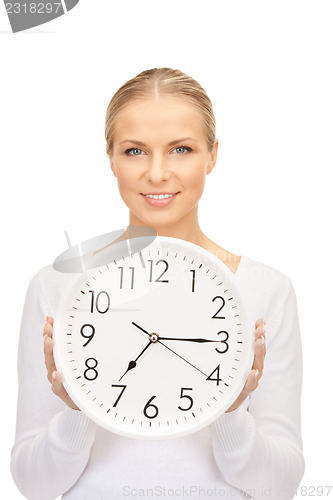 Image of woman holding big clock