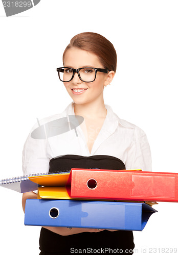 Image of young attractive businesswoman with folders