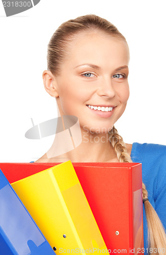 Image of young attractive businesswoman with folders