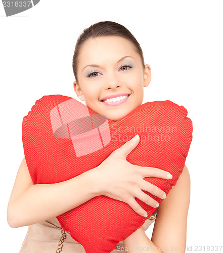 Image of woman with red heart-shaped pillow over white 