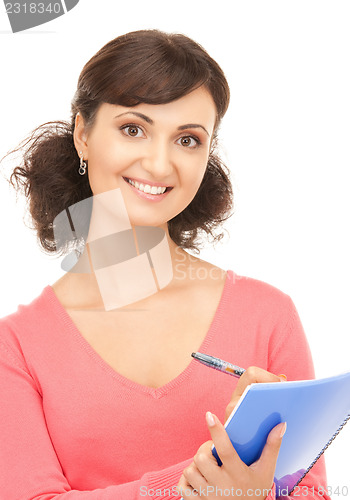 Image of young attractive businesswoman with notebook