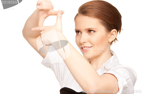Image of lovely woman creating a frame with fingers
