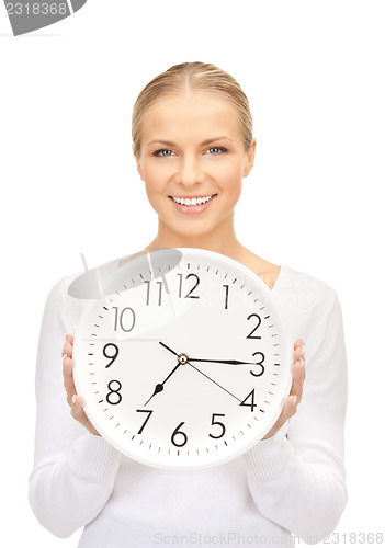 Image of woman holding big clock