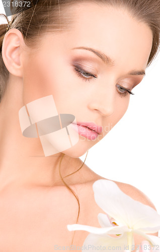Image of beautiful woman with white flower