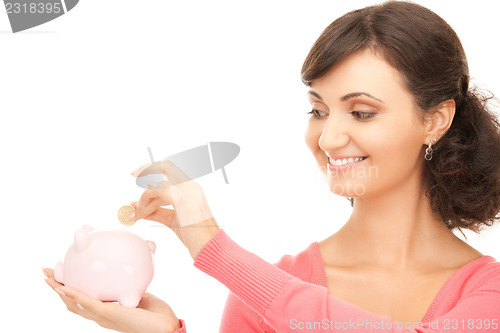 Image of lovely woman with piggy bank and money