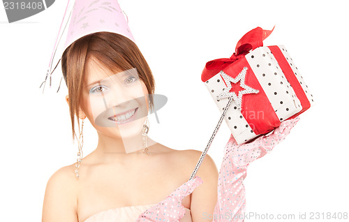 Image of teenage party girl with magic wand and gift box
