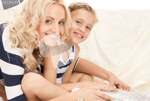 Image of happy mother and child with laptop computer