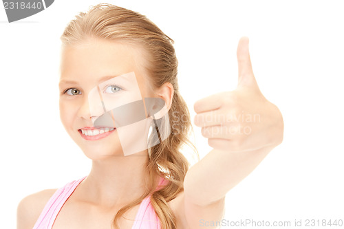 Image of lovely girl showing thumbs up sign