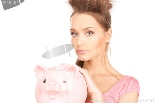 Image of lovely woman with piggy bank