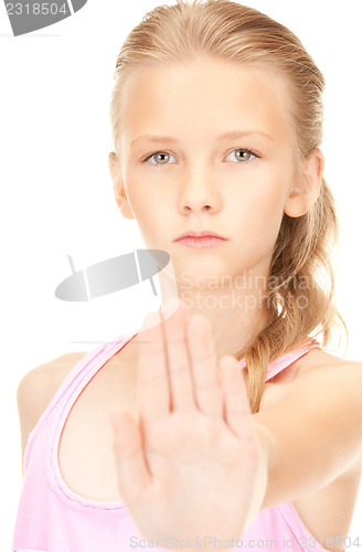 Image of lovely girl showing stop sign