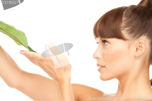 Image of woman with green leaf