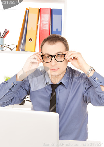 Image of businessman with laptop computer in office