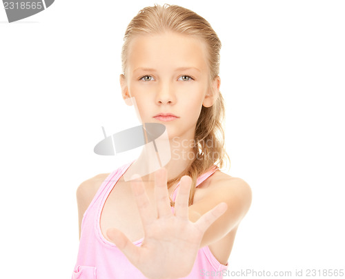 Image of lovely girl showing stop sign