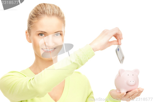 Image of woman with piggy bank and money