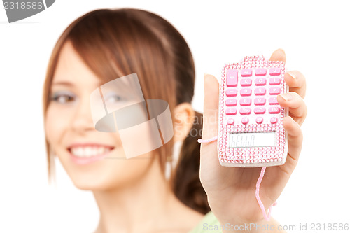 Image of lovely teenage girl with calculator