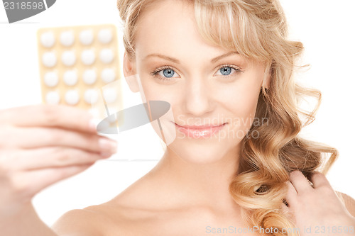 Image of young woman with pills