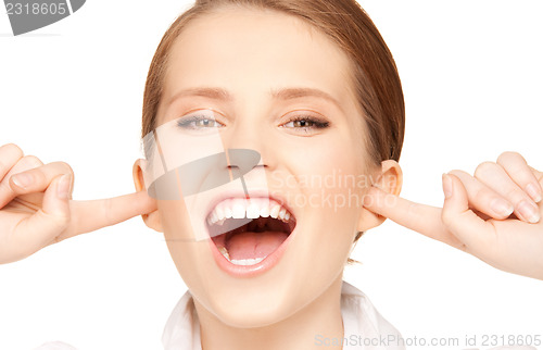 Image of woman with fingers in ears