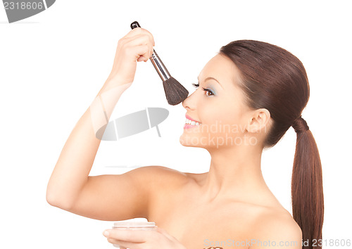 Image of lovely woman with powder and brush