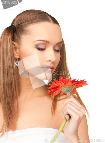 Image of woman in towel with red flower