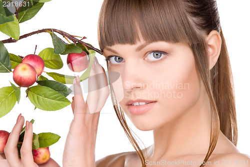 Image of lovely woman with apple twig