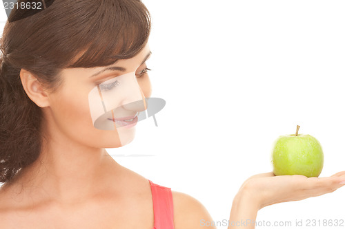 Image of young beautiful woman with green apple