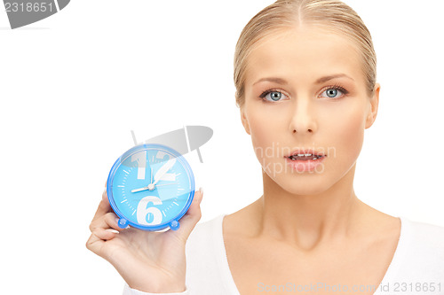 Image of woman holding alarm clock