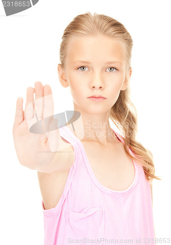 Image of lovely girl showing stop sign